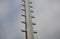 Power lines frozen by a large layer of ice layer in the shape of a cylinder with icicles. icing burdens the poles, ladder and ligh