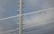 Power lines frozen by a large layer of ice layer in the shape of a cylinder with icicles. icing burdens the poles, ladder and ligh