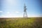 Power lines pylons next to a field