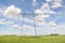 Power lines pylons next to a field