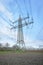 Power lines and substation, high voltage lines behind, electrical grid. High-voltage power line, transmission tower overhead line