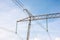 Power lines tower against the blue sky