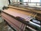 Power loom equipment weaving sarees by using wefts and plaiting using thousands of warps and this weaving industry running in