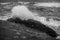 The power of nature: A wave crashing against a rock formation