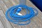 power outage, blue powerful cable roll with waterproof connector on vintage wooden surface,