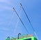 power outage, green trolleybus metal bars with stairs on blue sky with white clouds, parking area, urban transportation,
