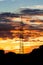 Power pole in front of colourful cloudy sky