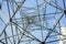 Power pylon from below against a blue sky