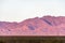 Power pylons in mountainous desert landscape at sunset, Mojave Desert, California, USA