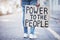 Power to the people cardboard protest poster in a city street for politics, government or human rights. Voice opinion