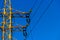 Power tower detail. Electric insulators mounted on rusty power-tower