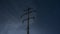 Power transmission lines against starry skies