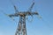 Power Transmission Tower. Air hi-voltage electric line supports on a blue sky background.