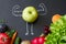 Power of vitamins diet abstract concept with green muscles  apple on blackboard