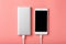 Powerbank charges a smartphone on a pink background. Universal external battery for gadgets Free space and minimalistic