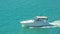 Powerboat or motorboat. Fishing boat on ocean waves. Ocean or Gulf of Mexico. Spring break or Summer vacations in Florida. Blue-tu