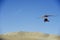 Powered glider flying above the desert