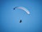 Powered paraglide or paramotor against blue sky. Paragliding