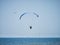 Powered paraglide or paramotor against blue sky. Paragliding