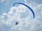 Powered paraglide or paramotor against blue sky. Paragliding