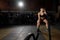 Powerful attractive muscular woman battle rope workout at the gym