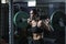 Powerful attractive muscular woman CrossFit trainer do workout with barbell