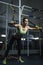 Powerful attractive muscular woman CrossFit trainer working out at gym