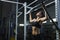 Powerful attractive woman CrossFit trainer do pull ups during workout