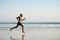 Powerful black man running barefoot by the sea