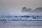 Powerful breaking waves on surf spot in hendaye in winter morning sunrise, basque country, france