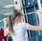 Powerful casual woman lifting weights in gym