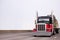 Powerful classic black and red big rig semi truck transporting r