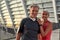 Powerful couple. Portrait of happy middle-aged man and woman in sport clothing looking at camera with smile while