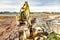 A powerful crawler excavator is working on a construction site. Close-up. Preparation of a pit for construction. Excavation