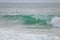 A powerful crystal green ocean wave on a beautiful beach, Phuket, Thailand