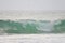 A powerful crystal green ocean wave on a beautiful beach, Phuket, Thailand