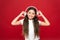 Powerful effect music teenagers their emotions, perception of world. Girl listen music headphones on red background