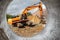 Powerful excavator at the construction site. View of the excavator through the pipe. Close-up of earthmoving machinery.