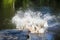 A powerful explosion in the water.The water column and spray scatter in different directions