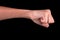 Powerful fist pump against black background