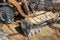 A powerful front loader on a construction site clears up the battle after dismantling reinforced concrete structures. Moving soil