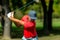 Powerful golf swing. Young golfing professional in golf swing