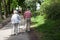 Powerful happy elderly people are walking with hiking sticks, canes