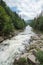 Powerful mountain river washed rocks in the woods