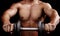 Powerful muscular man holding workout weight