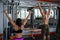 Powerful, muscular, strong, guy and girl, train back. The guy performs pull-UPS, the girl makes a craving for the head