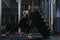 Powerful muscular woman CrossFit trainer doing tire workout at gym
