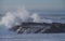 Powerful ocean wave breaks over rock outcrop at Windansea, La Jolla California