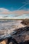 Powerful ocean wave crushes on stone shore. West coast of Ireland, Lahinch town, county Clare.