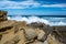 Powerful ocean waves crushing on sharp rocks.